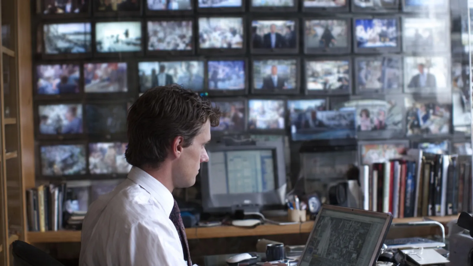 A man sitting in the office using his laptop
