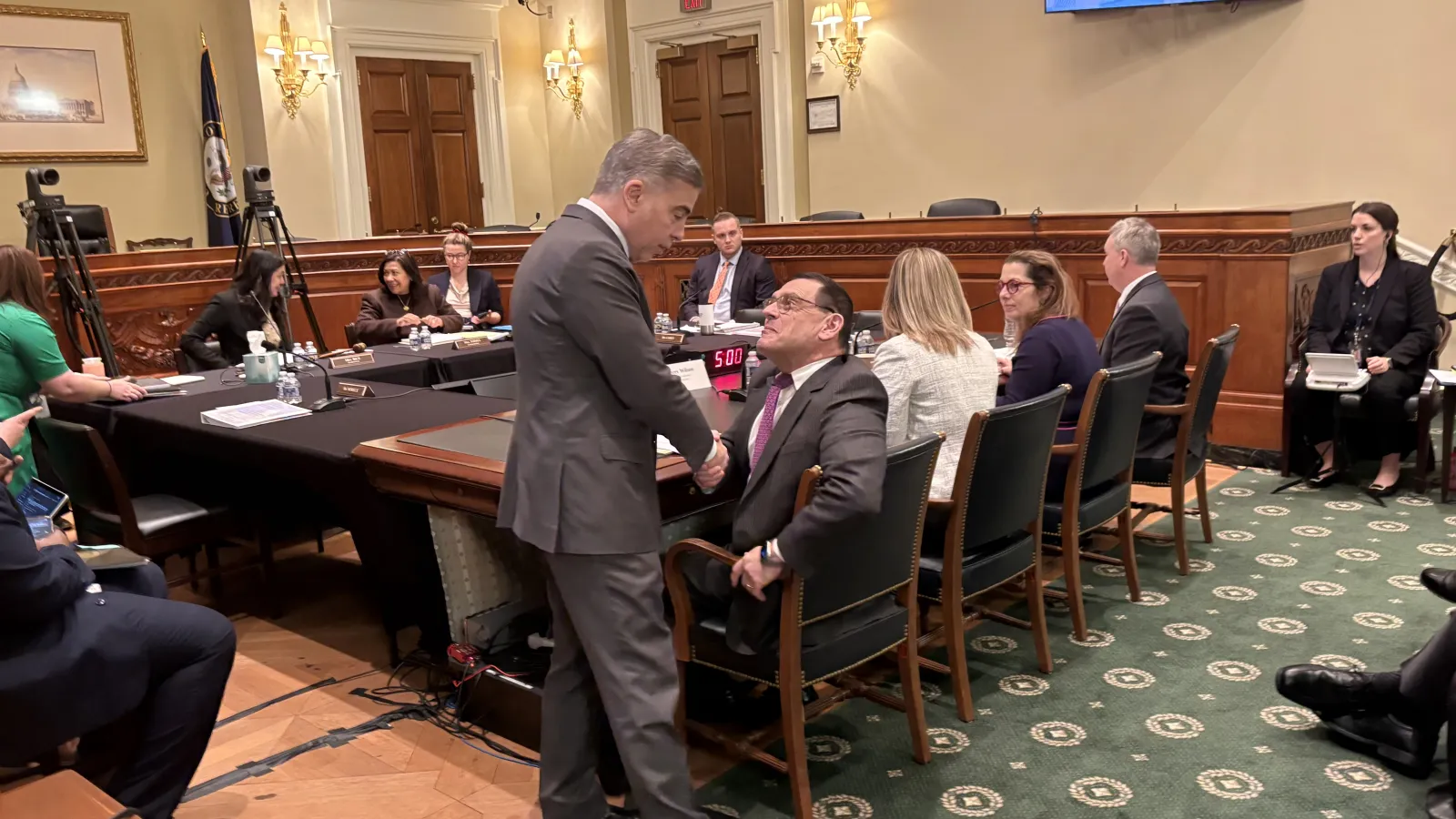 Michael Neblo holding shaking hands with a congress member 