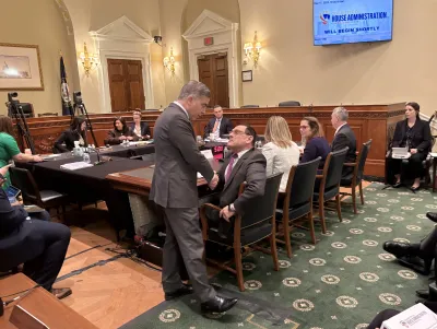 Michael Neblo holding shaking hands with a congress member 